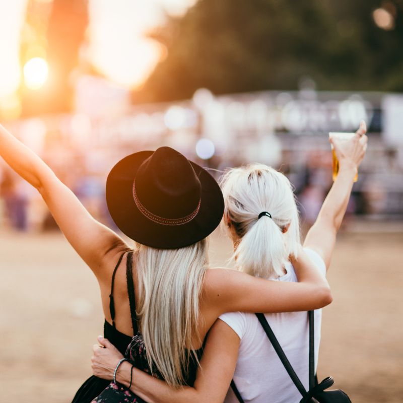 Two happy visitors at music festival - Toot sweet marketing
