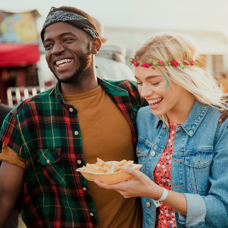 Two Audience Members laughing and chips - Toot Sweet Marketing
